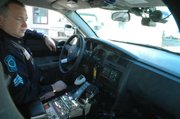 Lansing Police officer Billy Blackwell II looks at video being captured by the ICOP digital camera in his patrol car. Four of the Lansing Police Department's cars are outfitted with the new system, which Blackwell says is like having a partner in the car.