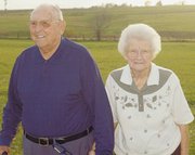 Carrol and Eva Belle Gerstenberger stand outside their former
property on Winchester Road. The Gerstenbergers recently downsized
to a duplex near the nursing home.