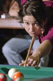 Nicolette Ducey, Bonner Springs, readies to make her shot last week during a game at Side Pockets in Bonner Springs. Ducey and three other women on the team, "4 Squaws," play pool together every Tuesday and Wednesday night. The women compete at tournaments in the Kansas City area and Topeka. And once a year, they compete at an international competition in Las Vegas.