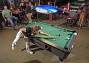 Keleigh Scheuermann, Lansing, shoots the six ball during a game at Side Pockets in Bonner Springs. Scheuermann and three other women on the team, "4 Squaws," play pool together every Tuesday and Wednesday night.
