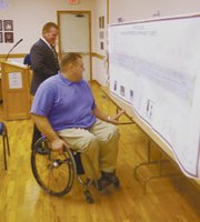 Councilmen Bill Whitten and Jeff Peterson peruse a preliminary
design for Eudora's new look in the downtown area.