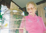Patrick cady/Eudora News Lela Morley gazes down at her pet parakeet
Sunshine. She and her husband have owned birds since before moving
to Eudora 35 years ago.