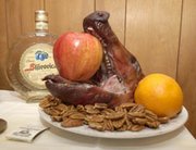 the head of the roasted pig sits on a table with the bottle of plum brandy - When Is Serbian Christmas the head of the roasted pig sits on a table with the bottle of plum brandy - When Is Serbian Christmas