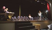 The final two competitors in the Eudora Middle School spelling bee
took turns spelling words in front of the judges. Eighth-grader
Chelsea Grammer awaits the outcome of her last word. Austin
Vickers, the eventual winner of the bee, is seated behind her.