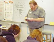 John Drees reads the opening lines of Truman Capote's "In Cold
Blood" to Jennifer Perez's second hour honors English class. Drees
spent his childhood in Holcomb where the murders at the heart of
the novel occurred.
