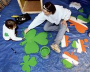 With a little luck of the Irish and a lot of paint, Sarah Book of
Shawnee and her 2-year-old daughter Frankie were getting the color
shamrocks ready in preparation for the St. Patrick's Day Parade in
downtown Kansas City.