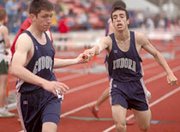 Eudora senior Cody Burns hands off the baton to junior Jordan
Katzfey at Friday's Baldwin Invitational. As a whole, the boys team
took second place at the meet.