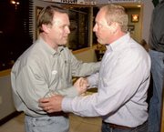 After weeks of often-heated campaigning, candidates Kevin Straub,
left, congratulated Don Clark for his win Tuesday night at JT's
Grill & Sports Bar in De Soto. Clark defeated Straub for the
at-large position on the De Soto School Board.
