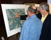 Tom Schrempp, right, Johnson County Water District No. 1's director of production, describes the utility's expansion plans to an area resident on Thursday, March 29 at an informational meeting in Lansing. WaterOne wants to build a water treatment plant south of Lansing on Kansas Highway 5.