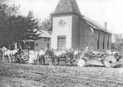 Decorated wagons line up for a parade in De Soto in this photo with
no date and no explanation. The Methodist Episcopal Church in the
background stood just to the south of Abbott Hall on Peoria Street,
which at that time did not even have gravel.