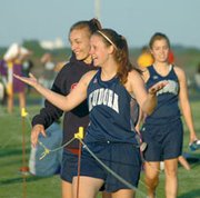 Eudora sophomores Alisha Wingebach and Kendal Abel look to a
teammate Friday after Eudora's 400-meter relay team, of which they
are members, qualified for the state track meet. The relay finished
in second place at the Santa Fe Trail regional and will compete
again this weekend in Wichita