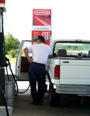 Terry Rush, Lansing, fills his pickup truck at a cost of $3.09 per gallon. Despite gasoline prices in excess of $3 a gallon, many drivers say they aren't changing their habits.