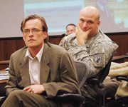 Bart Dean, left, an associate professor of anthropology at Kansas University, and Lt. Charles Bartles listen to an audience member's comment during the "military-social science roundtable" Thursday, June 21, at Fort Leavenworth.