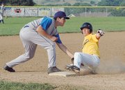 Landon Cole of the Leavenworth Wranglers slides safely into third for a triple just ahead of Lansing Cubs third baseman Greg List's tag.