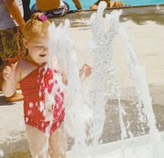 Two-year-old Haley Barham frolics in the fountains Saturday in the
Eudora Aquatic Center's zero-depth entry area. The center opened
for the first time last weekend after wet weather caused several
construction delays. More pool photos can be found on page 8A.
