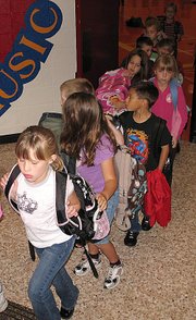 Students of Lansing Elementary School leave the gym Wednesday morning and head toward their classrooms to begin another day. The number of students enrolled at the elementary school dropped by two this year, but the number of students in the entire district increased by 99.