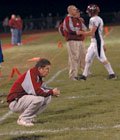 Eudora senior quarterback Brynnen Webb walks off the field while
his father, coach Gregg Webb, mulls over the team's 13-8 upset loss
to Basehor-Linwood in the first round of the Class 4A playoffs.
Eudora finished the season 8-2.