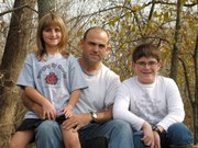 Lt. Col. Brad Pippin, center, is back in Lansing after serving six months in Baghdad. Pippin, flanked by his daughter, Rebecca, and son, Wes, was in the Pentagon when it was attacked on Sept. 11, 2001.