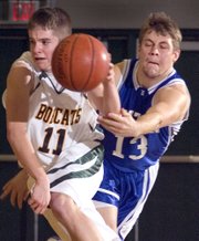 BLHS sophomore Mark Vaca (11) makes a quick break away with the ball as he is fouled by Holton senior Anthony Schuetz Saturday night.