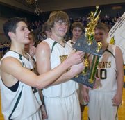 Chandler Schaake (left) and Tanner Swafford check out their first place trophy after defeating Holton 55-54 Saturday in the Bobcat Basketball Invitational.