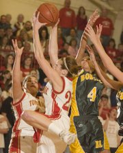 Tonganoxie senior Shannon Carlin snags a missed shot rebound from Basehor-Linwood on Friday night. The Chieftains won the game in overtime, 50-44.
