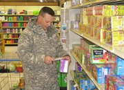 Maj. Scott Holland, Lansing, shops at Fort Leavenworth's Commissary Wednesday, March 5. Holland said he's seen price increases for basic items like meat and milk, but he also said prices, in general, are significantly less than at grocery stores off-post.