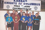 Sam Lorenzen, at far right in front row, won the Knights of Columbus State Free Throw Championship on Sunday, March 2, in Salina at the Sacred Heart High School gymnasium. Lorenzen made 21 out of 25 free throw attempts, two more than his closest competitor, in winning the 10-year-old boys age division. Lorenzen is pictured with the winners from all age divisions, as well as State Deputy Donald Wagner. By winning his age division, Lorenzen's score was sent to the Knights of Columbus Supreme Council, where he could be selected to compete in the international contest.