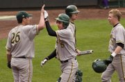 Justin Gripka (5) and Ryan Lawless celebrate their runs with teammates during the sixth inning Friday.