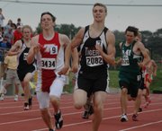 Jeremy Carlisle, Tongaonoxie, and Dillon Cowing, Clay Center, race toward the finish line in the boys 800-meter run. Cowing beat Carlisle by just .48 seconds to win a state title.