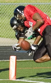 The Kansas Kaos' Allen Williams (left) bobbled the ball but came up with the grab for a touchdown early in the game against the Cass County Renegades Saturday at David Jaynes Field.