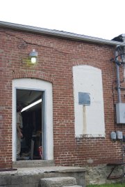 The southwest corner of the Kessinger Real Estate building caved in sometime Wednesday. Mitch Elliot stands in the doorway inspecting the interior damage.