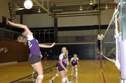 Baldwin High School senior Olivia Catloth, left, hits a ball during the Bulldogs' match versus Tonganoxie.