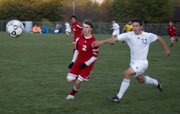 Jamison Bloomer battles a Kansas City Christian defender for position as the two streak up the sideline after the ball during Tonganoxie High’s Class 4-3-2-1A road playoff regional match with the Panthers on Monday night at Alvey Park in Kansas City, Kan. KCC defeated THS, 3-0.