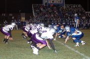 Baldwin High School, left, squared off with Perry-Lecompton Friday night in a Class 4A district football game. Baldwin opened the game with a 21-0 lead, but Perry-Lecompton rallied with 28 unanswered points. However, Baldwin finished the game on a 14-0 run to win, 35-28.