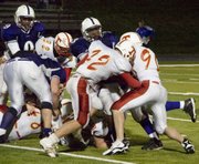 Jeremie Maus and Jeremy Elliott bring down a Piper ball carrier during Tonganoxie’s 29-26 victory over the Pirates.