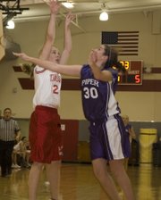 Alissa Donnelly draws a foul from a Piper defender during the TMS seventh grade girls’ 35-15 loss on Thursday.