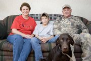 Melissa Ostermeyer, left, will be donating a kidney to her son, Jacob, middle, who is 16 and has a kidney disease. Jacob’s father, Kieth, right, also volunteered to donate a kidney, but he was not a match; Melissa was. In the foreground is the family’s dog, Sadie.