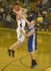 McLouth High senior forward Derrick Crouse elevates over a St. Marys defender for a jump shot during the Bulldogs' 63-20 loss to the Bears on Friday night at McLouth.