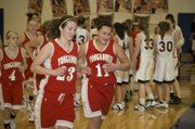 Tonganoxie High seniors Chrissie Jeannin and Roni Grizzle run off the floor following the Chieftains' narrow defeat of Bishop Ward at Kansas City, Kan., on Friday night. The two seniors combined for 33 points in the 48-46 THS victory.