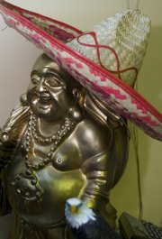 A Buddha wearing a sombrero sits behind the cash register at Jasmin restaurant, 719 Main St., Eudora.