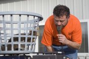 Adam Bryant, owner of Adam’s Feed Store, uses an electronic scale to get the exact weight of the squirrels brought in during Saturday’s scramble. The top team’s squirrels weighed in at 14 pounds, 14 ounces.