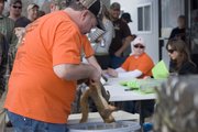Randy Smiley checks to make sure each team has the right number of squirrels – five gray and five red – before moving them to the scale to be weighed. Smiley and Adam Bryant, owner of Adam’s Feed Store, were the original founders of the Squirrel Scramble.