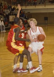 Brandon Yoder drives the lane during Tonganoxie’s 19-point sub-state win on Monday at THS. Yoder scored eight points in 12 minutes off the bench.