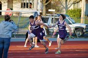 Baldwin High School senior Andy Thurlow hands the baton to sophomore Josh Hoffman during the boys' 400-meter relay Friday.