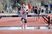 Baldwin High School senior Corinna Papps takes a big step in the water barrier as she leads the 2,000-meter steeplechase Friday. Papps won the race and came within two seconds of the school record.