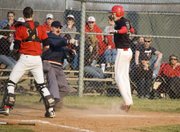 A hopeful Brandon Yoder gives the sign for safe as he is called out at home during Tonganoxie High's 8-7 win against Jeff West on April 7.