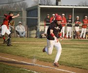 Dylan Caywood hustles down the first-base line for a bunt single during Tonganoxie High's 8-7 win over Jeff West on April 7.