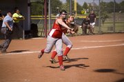 Pitcher Angela Jacobs makes a throw to first base after fielding a bunt during Tonganoxie's loss to Bishop Ward at Eudora.
