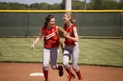 Shortstop Kaitlyn Wolken and second baseman Brooklyn Kerbaugh share a laugh after they collided at second base but still got a double play.