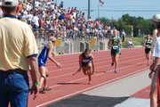 Pittsburg-St. Mary's Colgan runner Emmalia White stumbles forward while trying to hand off the baton to teammate Faith Miller during the Class 2A 3,200-meter relay on Friday at the Track and Field State Championships. Maranatha freshman Christa Courtney can be seen at the far right closing the gap.